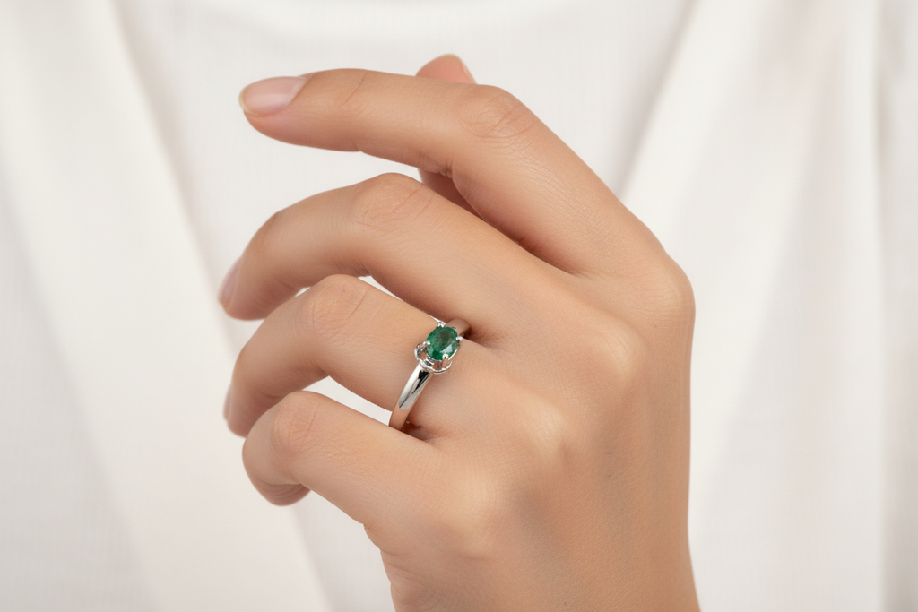 14K White Gold Oval Emerald Solitaire Ring on Model's Finger