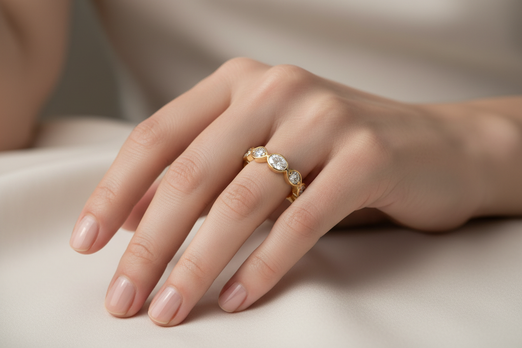 14K Yellow Gold Oval & Round Diamond Wedding Band worn on model's hand