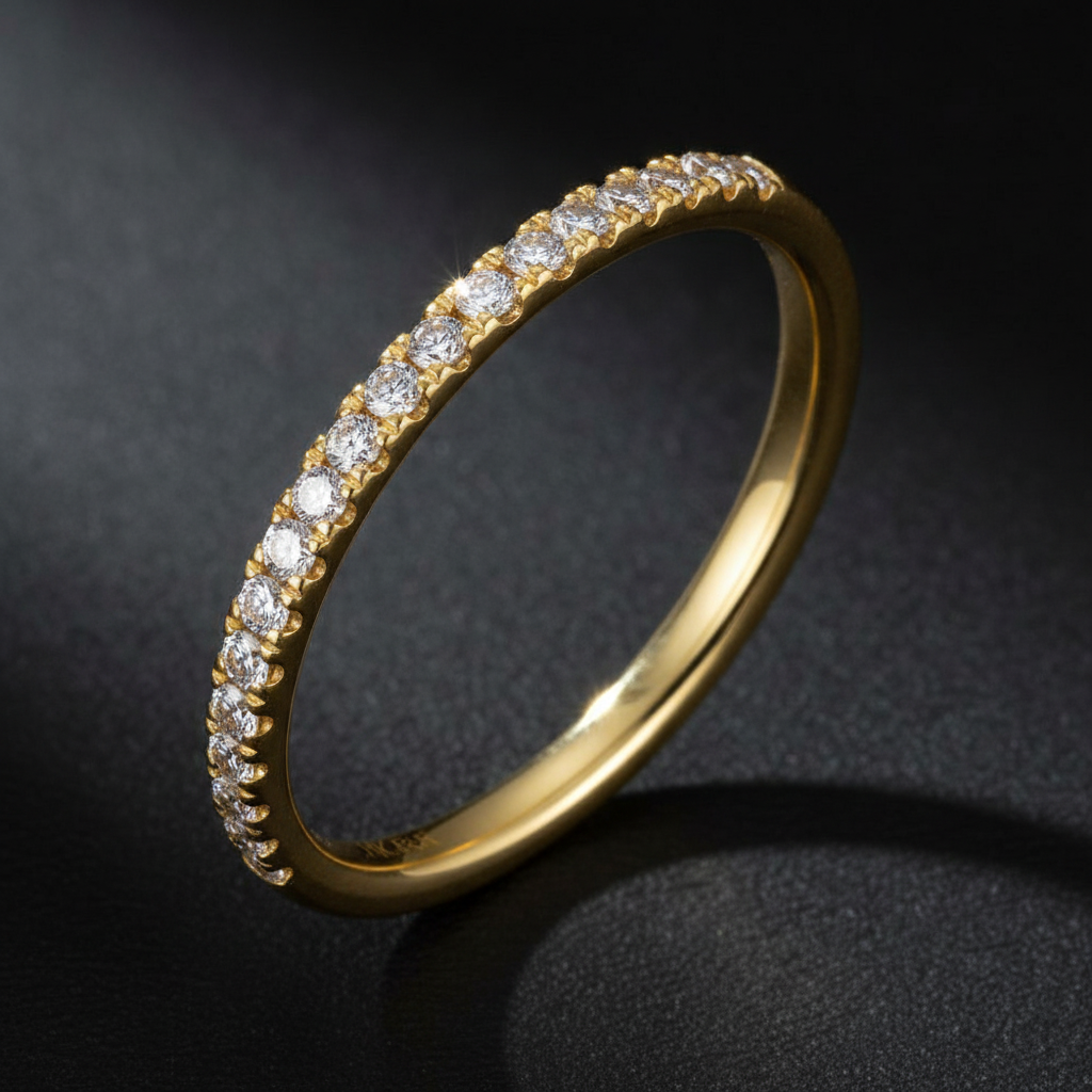 14K yellow gold micro-pavé straight diamond wedding band on a dark background