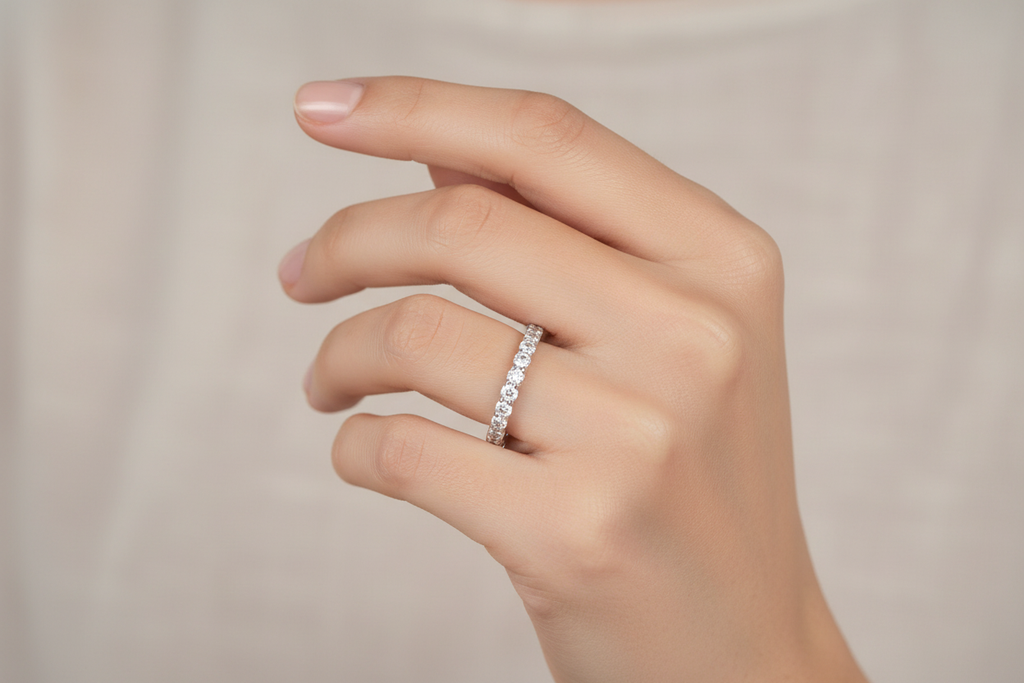 Model wearing 14K white gold shared prong diamond straight wedding band