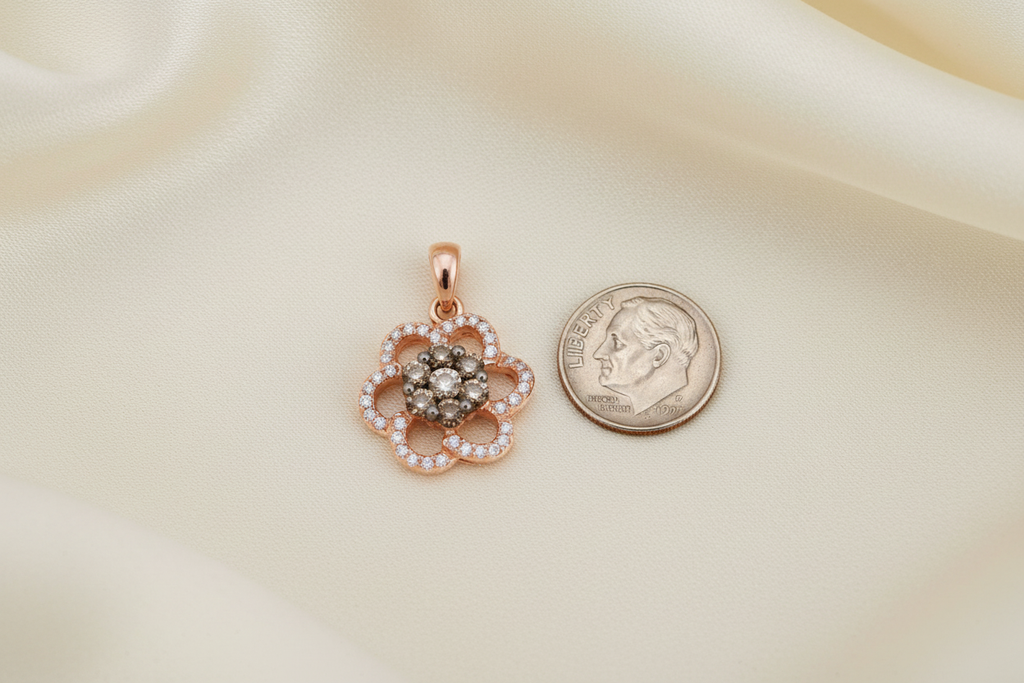 14K rose gold diamond flower cluster pendant next to a US dime showing true petite scale