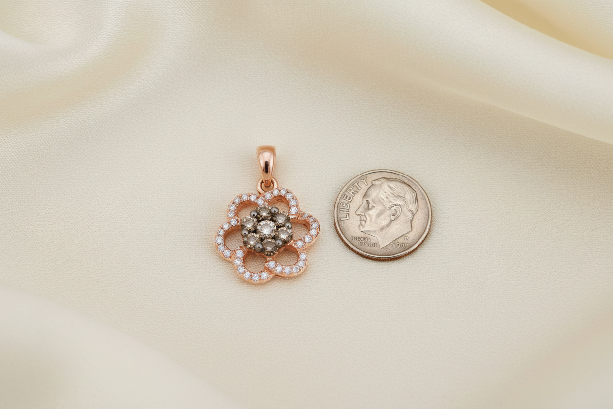 14K rose gold diamond flower cluster pendant next to a US dime showing true petite scale