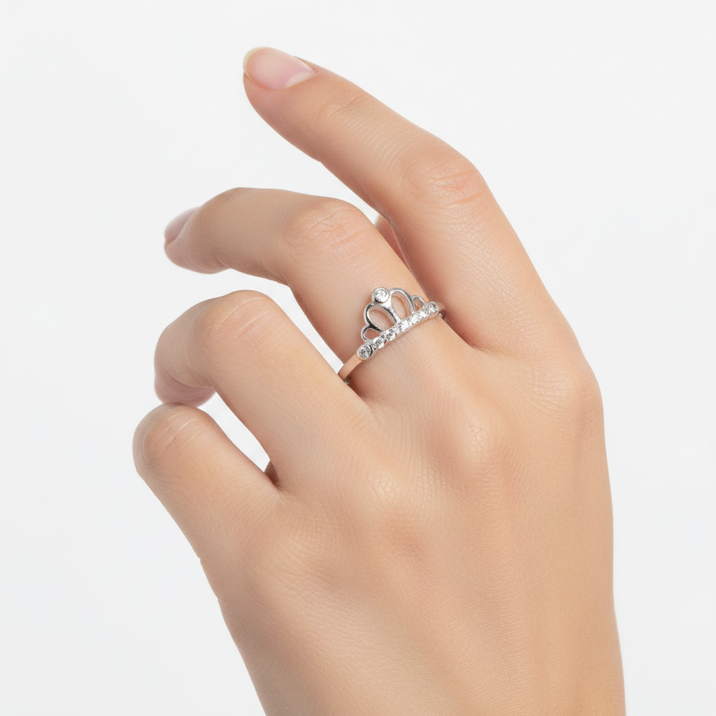 Sterling silver CZ crown tiara ring worn on young woman's hand, true to scale lifestyle jewelry photography