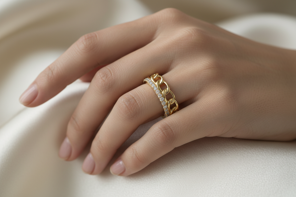 14K yellow gold chain link and micro-pavé diamond wedding band worn on a model's hand