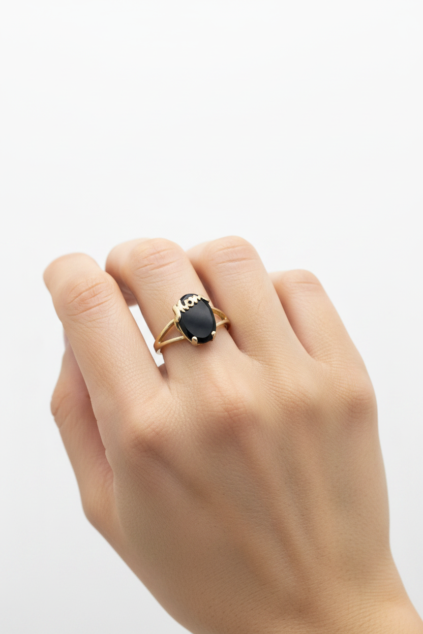 10K yellow gold Mom script ring with oval black onyx stone worn on model's hand