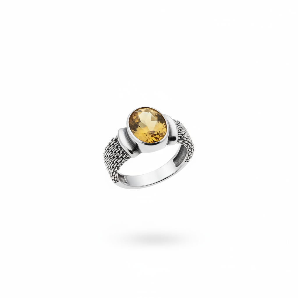 Oval citrine bezel set cocktail ring with sterling silver link chain band, suspended on white background