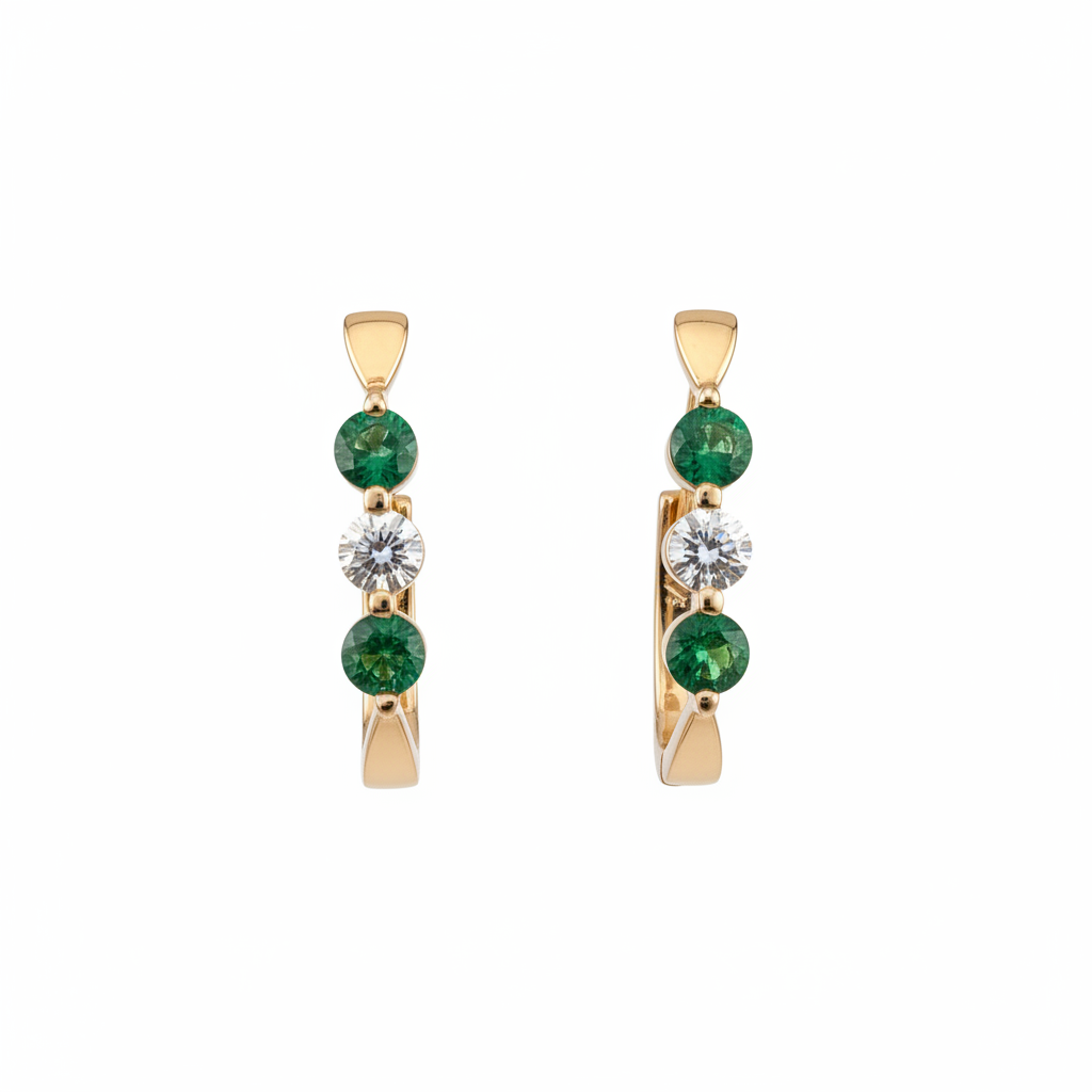 Gold hoop earrings with emerald and diamond accents on white background