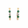 Gold hoop earrings with emerald and diamond accents on white background