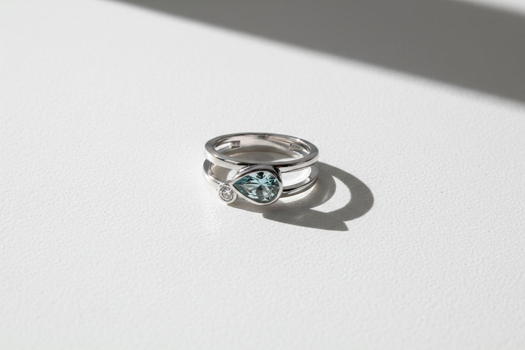 10K White Gold Pear Aquamarine & Diamond Minimalist Ring modern sleek flat lay