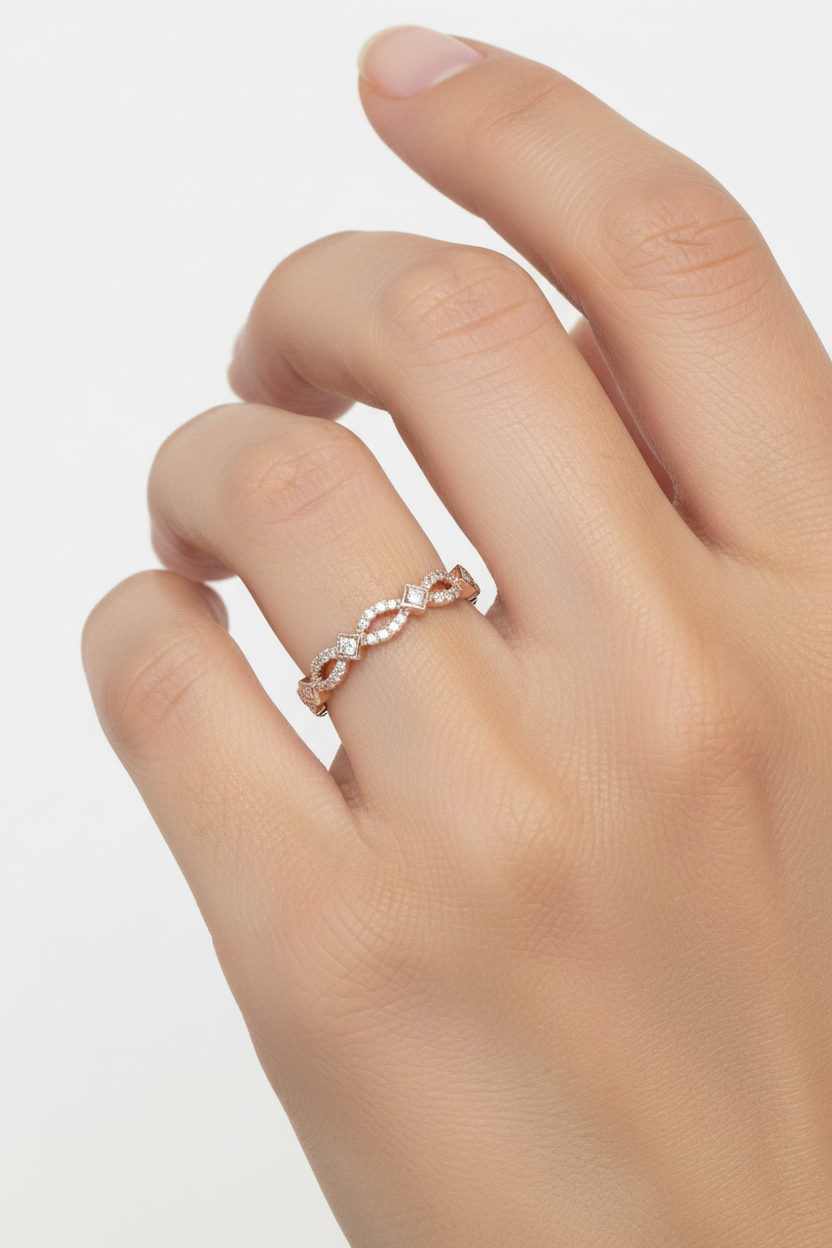 14K rose gold diamond milgrain stackable band ring worn on model's finger
