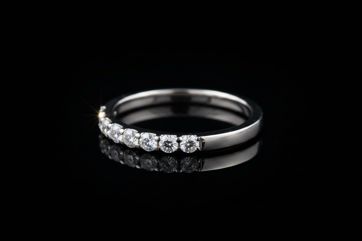 14K white gold diamond wedding band on dark background, side profile angle