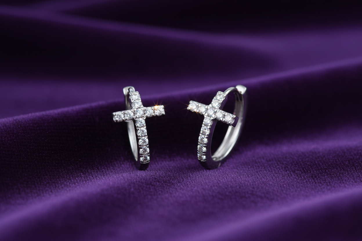 14K white gold diamond cross hoop earrings on rich deep purple velvet fabric