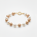 Pearl and rose gold bead station bracelet with ring clasp on white background