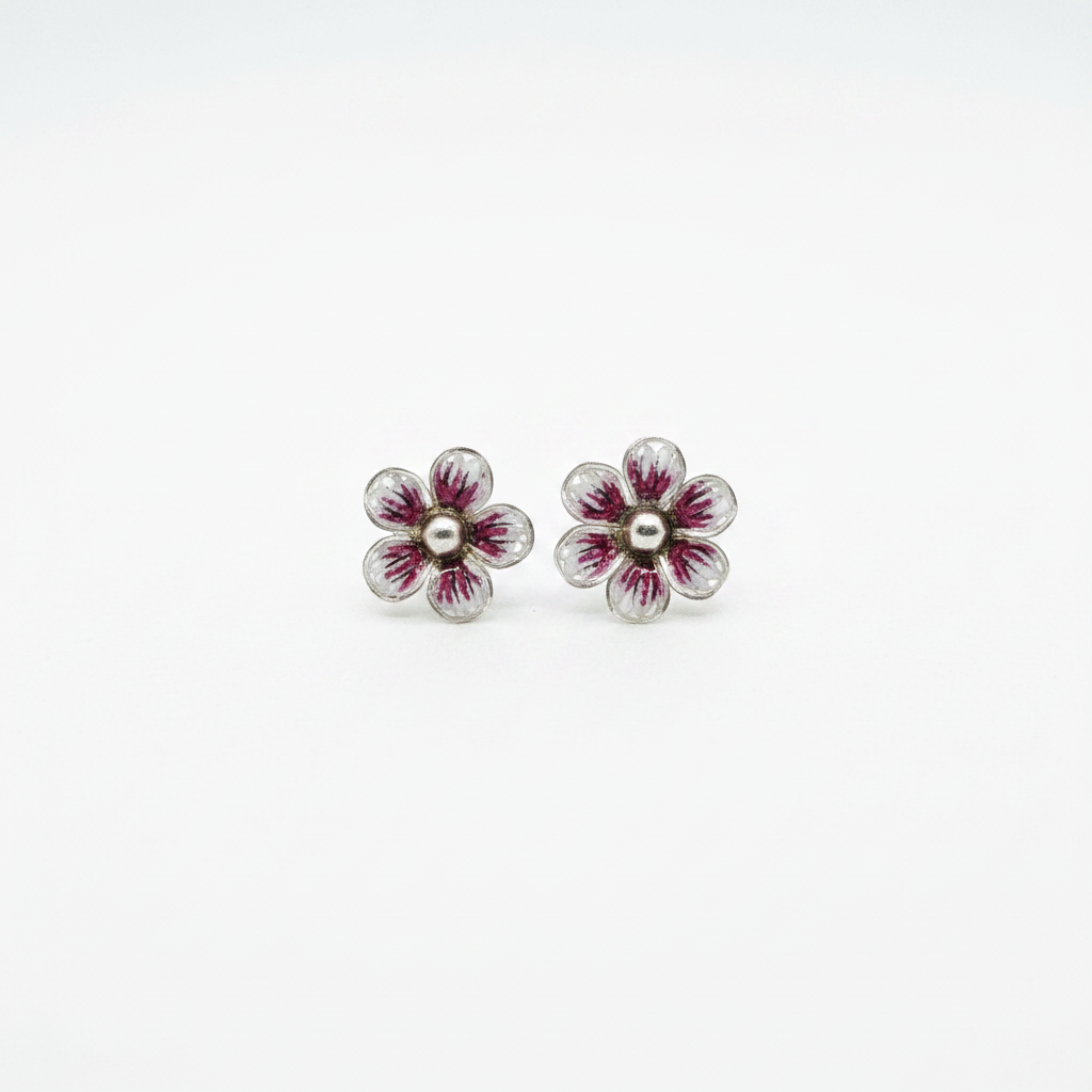 Sterling silver hand-spun filigree pink and white enamel flower stud earrings on white background