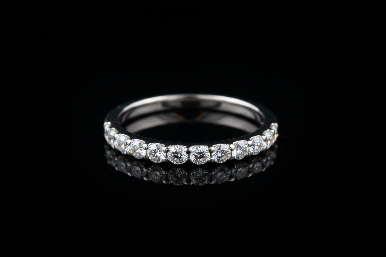 14K white gold diamond wedding band on dark background with dramatic studio lighting