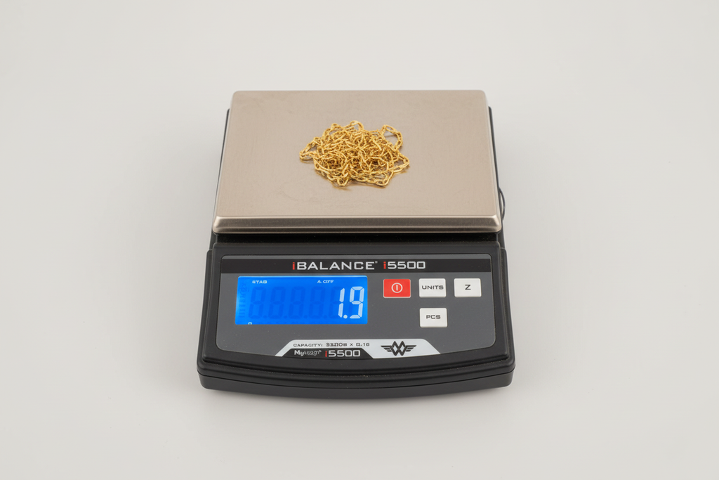 9 Karat Yellow Gold Chain on scale with clean white background