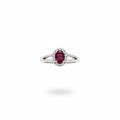 Oval ruby and diamond halo ring in 14kt white gold suspended on white background
