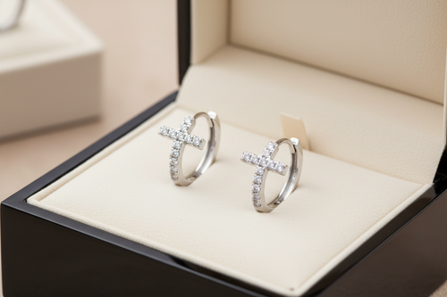 14K white gold diamond cross hoop earrings displayed in an elegant jewelry box