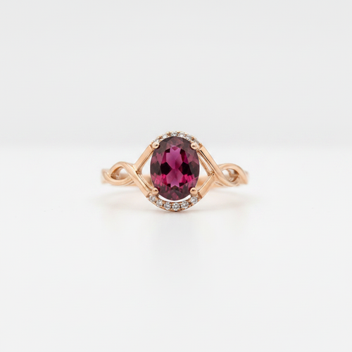10K rose gold oval rhodolite garnet ring with diamond accents on white background
