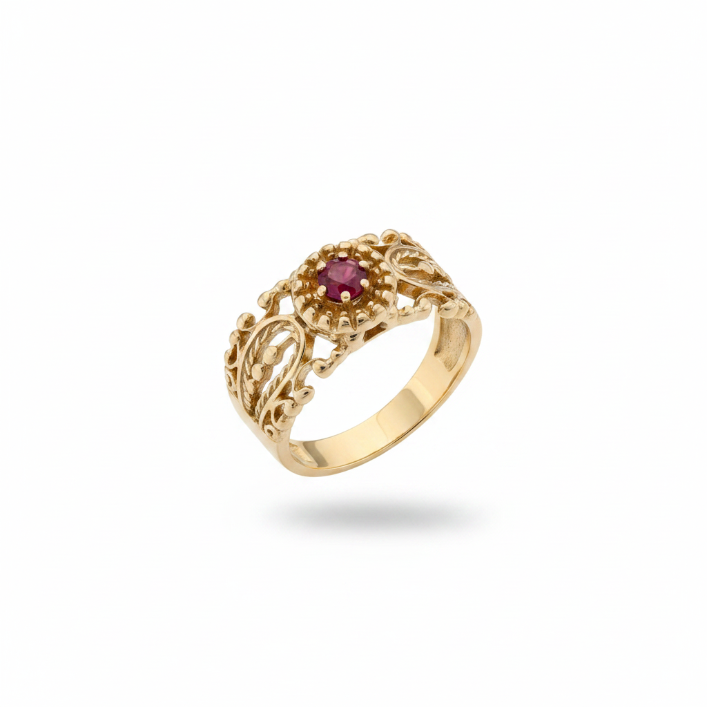 Ruby filigree band ring in 14kt yellow gold tilted to show top face detail, suspended on white background