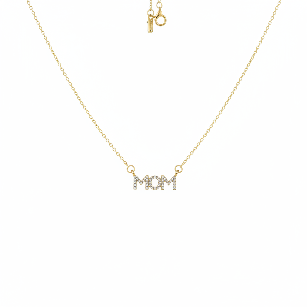 Gold-tone crystal pavé MOM letter bar necklace suspended on white background